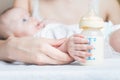 Baby holding a baby bottle with breast milk Royalty Free Stock Photo