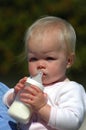 Baby holding bottle