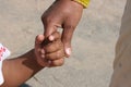 Baby holding a caring mothers hand