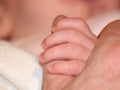Baby holding fathers thumb Royalty Free Stock Photo