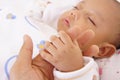 A baby holding his fathers finger Royalty Free Stock Photo