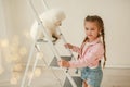 Baby Hugs the white fluffy puppy. Kids Royalty Free Stock Photo