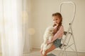 Baby Hugs the white fluffy puppy. Kids Royalty Free Stock Photo