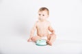 Baby with Icing on His Mouth Sitting Next to Cake Royalty Free Stock Photo