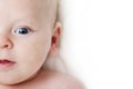 Baby infant close-up portrait. Happy baby face over light background. Looking at camera. Copy space Royalty Free Stock Photo