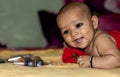 Baby infant cute holding lipstick with blurred background