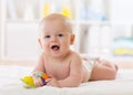 Baby infant lying on belly weared diaper with teether Royalty Free Stock Photo