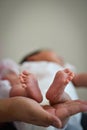 Baby Infant's Precious Feet Over Mother's Hand - Innocence Conce