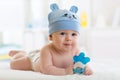 Crawling baby weared funny hat and diaper in nursery room Royalty Free Stock Photo