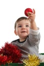 Baby inside a box showing a christmas ball