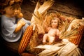 Baby Jesus care by an angel, xmas card Royalty Free Stock Photo