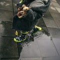 Baby kid with spotted boots playing over rain puddles in urban landscape Royalty Free Stock Photo