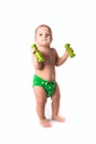 Baby kid, toddler in green diapers doing exercises with dumbbel Royalty Free Stock Photo