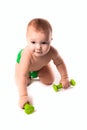 Baby kid, toddler in green diapers doing exercises with dumbbel Royalty Free Stock Photo