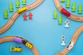 Baby kid toys background. Toy train and wooden rails on blue background. Top view. Children toys a trains and cars traveling on
