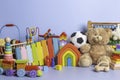 Baby kid toys collection isolated on blue background. Teddy bear, wooden, plastic and fluffy educational baby toy set Royalty Free Stock Photo