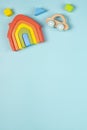 Baby kids toy for children with wooden rainbow house, car, colorful blocks on light blue background. Top view, flat lay Royalty Free Stock Photo