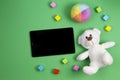 Baby kids toys background. Teddy bear, colorful cubes blocks and tablet computer on green background Royalty Free Stock Photo