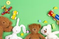 Baby kids toys background. Teddy bears, wooden train, toy cars, colorful blocks on light green background. Top view Royalty Free Stock Photo