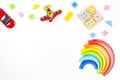 Baby kids toys background. Wooden educational geometric stacking blocks toy, rainbow, airplane, car and colorful blocks Royalty Free Stock Photo