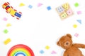 Baby kids toys background. Wooden educational geometric stacking blocks toy, wooden train, rainbow, teddy bear and Royalty Free Stock Photo