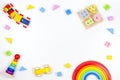 Baby kids toys background. Wooden educational geometric stacking blocks toy, wooden train, car, rainbow, airplane and Royalty Free Stock Photo