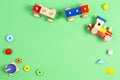 Baby kids toys background. Wooden toy train and wood stacking pyramid tower on light green background. Top view Royalty Free Stock Photo
