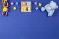 Baby kids toys background. Wooden train, blue teddy bear, shape color recognition puzzle stacker and colorful blocks on Royalty Free Stock Photo