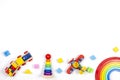 Baby kids toys background. Wooden train, rainbow stacker, red plane, stacking rings tower pyramid toy and colorful Royalty Free Stock Photo