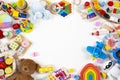 Baby kids toys frame. Set of colorful educational wooden, plastic and fluffy toys on white background. Top view, flat