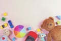 Baby kids toys frame with teddy bear, toy cars, colorful bricks on pink background Royalty Free Stock Photo