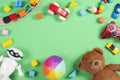 Baby kids toys frame with teddy bear, toy cars, robot, colorful bricks, cubes on pink background Royalty Free Stock Photo