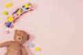 Baby kids toys frame with teddy bear, toy train, colorful wooden bricks on pastel pink background. Top view, flat lay Royalty Free Stock Photo