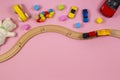Baby kids toys frame with toy car, wooden train, colorful cubes, teddy bear, on pink background. Top view Royalty Free Stock Photo