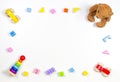 Baby kids toys frame on white background with teddy bear, wooden cars, toy pyramid and colorful building blocks. Top Royalty Free Stock Photo