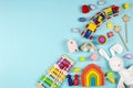 Baby kids toys on light blue background. Colorful educational wooden and musical toys. Top view, flat lay Royalty Free Stock Photo