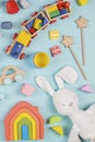 Baby kids toys pattern. Set of colorful educational wooden and fluffy toys on blue background. Top view, flat lay Royalty Free Stock Photo