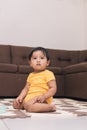 baby kneeling in the living room of the house watching Royalty Free Stock Photo