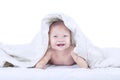 Baby laughing inside blanket - isolated Royalty Free Stock Photo