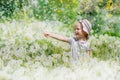 Baby laughs in a dandelion field Royalty Free Stock Photo