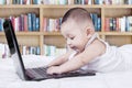 Baby learn to use laptop on bed Royalty Free Stock Photo