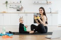 Baby learning exercises with stretch band from mom at home