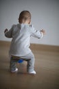 Baby learning how to walk on her first hunt for a ball Royalty Free Stock Photo