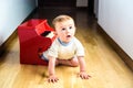 Baby learning to play the piano with a wooden toy instrument, a tender and funny childhood scene