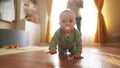 baby learns to crawl on the floor at home. happy family a kid dream concept. baby son crawling on the floor first steps Royalty Free Stock Photo