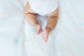 Baby legs on the bed, soft focus newborn tiny feet, lower body. Royalty Free Stock Photo