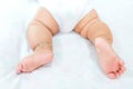 Baby legs on the bed, soft focus newborn tiny feet, lower body. Royalty Free Stock Photo