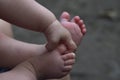 Baby legs and handles close up on gray background