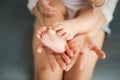 Baby legs in mother hands on white background Royalty Free Stock Photo