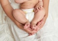 Baby legs in mother hands on white Royalty Free Stock Photo